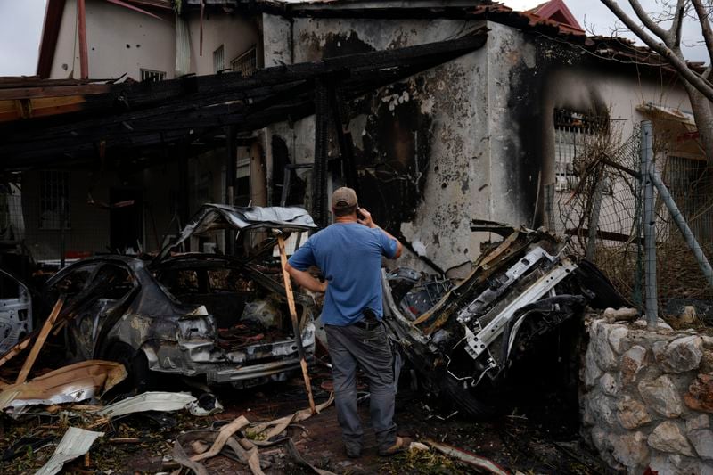 A man looks at a house hit by a rocket fired from Lebanon, in Moreshet, northern Israel, on Sunday, Sept. 22, 2024. (AP Photo//Ariel Schalit)