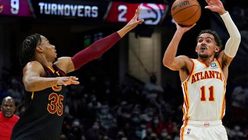 Atlanta Hawks' Trae Young (11) shoots against Cleveland Cavaliers' Isaac Okoro (35) during the second half of an NBA basketball game Friday, Dec. 31, 2021, in Cleveland. (AP Photo/Tony Dejak)