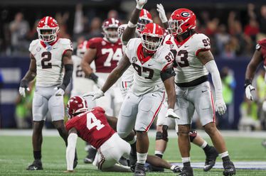 Georgia Bulldogs defensive lineman Warren Brinson (97) reacts with Georgia defensive lineman Tyrion Ingram-Dawkins (93) after tackling Alabama Crimson Tide quarterback Jalen Milroe (4) during the first half of the SEC Championship football game at the Mercedes-Benz Stadium in Atlanta, on Saturday, December 2, 2023. (Jason Getz / Jason.Getz@ajc.com)