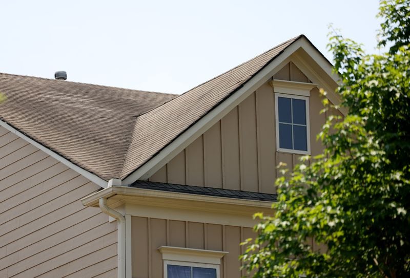 The condition of the roofs of these townhomes in the Village Grove subdivision in Suwanee is at the center of a bitter dispute that has pitted a group of neighbors against the homeowner's association. The question hanging over the conflict is: Did a hail storm cause damage to the roofs or did they deteriorate from two decades of wear? (Jason Getz / Jason.Getz@ajc.com)