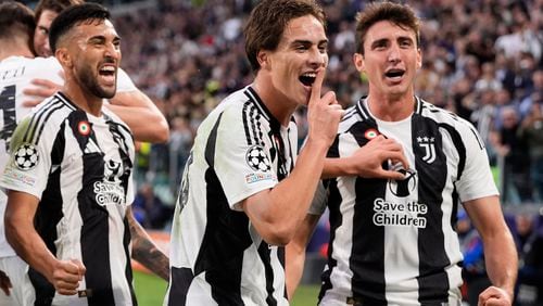 Juventus' Kenan Yildiz, center, celebrates after scoring the opening goal during the Champions League opening phase soccer match between Juventus and PSV Eindhoven at the Juventus stadium in Turin, Italy, Tuesday, Sept. 17, 2024. (Fabio Ferrari/LaPresse via AP)