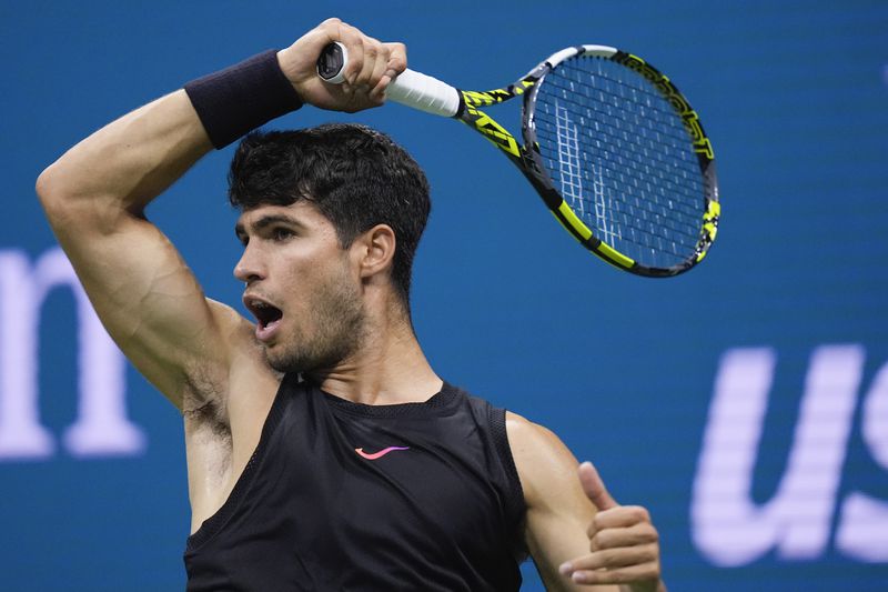 Carlos Alcaraz, of Spain returns a shot to Botic van De Zandschulp, of the Netherlands, during the second round of the U.S. Open tennis championships, Thursday, Aug. 29, 2024, in New York. (AP Photo/Matt Rourke)