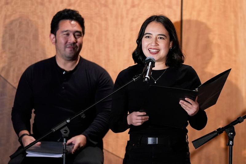 Lillian Mimi McKenzie, right, performs in "What Do I Do With All This Heritage?" on Wednesday, May 22, 2024, in Los Angeles. The show offers more than 14 true stories of Asian American Jews. Kenzo Lee is at left. (AP Photo/Ashley Landis)