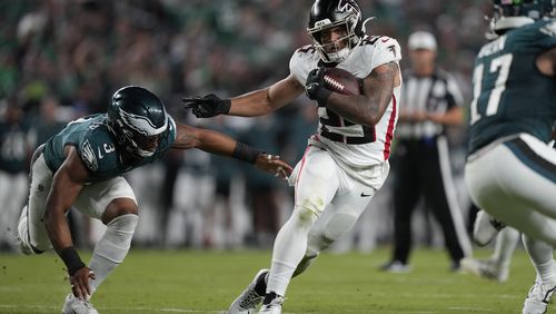 Atlanta Falcons running back Tyler Allgeier (25) runs with the ball near Philadelphia Eagles linebacker Nolan Smith Jr. (3) during the second half of an NFL football game Monday, Sept. 16, 2024, in Philadelphia. (AP Photo/Matt Rourke)