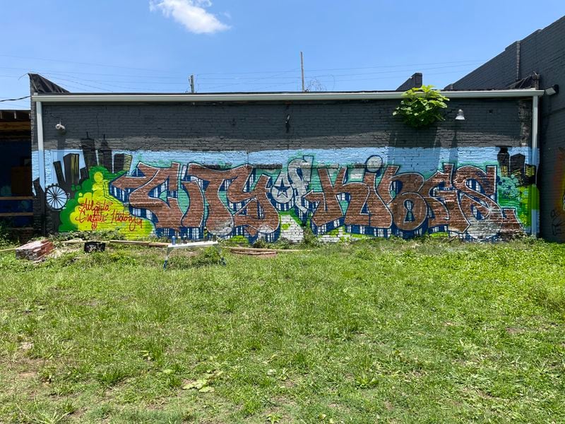 A piece titled, "City of Kings," is located behind a building in southwest Atlanta.