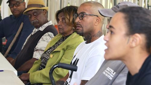 Members of the Livsey Family listen as Alexis Livsey, 25, (far right) speaks to the media about Gwinnett County trying to acquire 10 acres of their land in Snellville on Friday, April 14, 2023. (Natrice Miller/ natrice.miller@ajc.com)