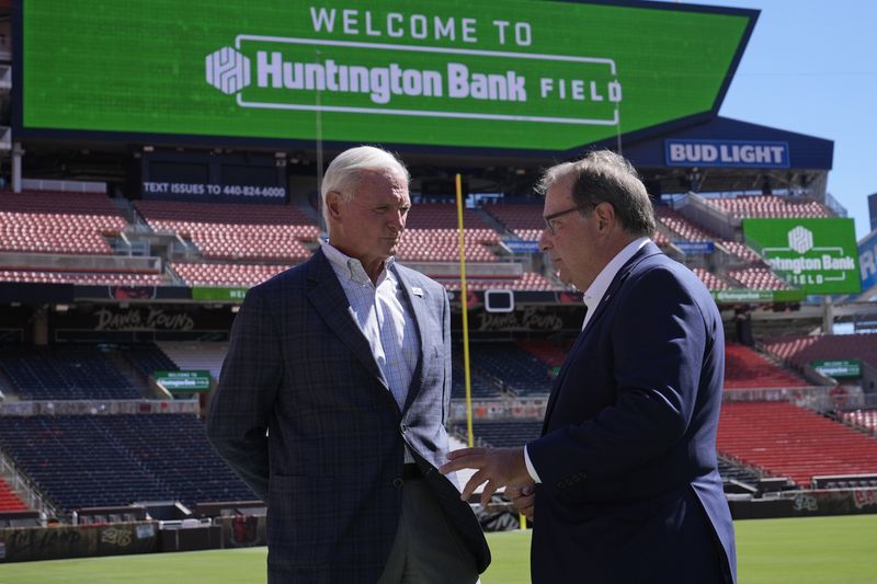 Cleveland Browns owner Jimmy Haslam, left, and Huntington Banks' Steve Steinour, right, Huntington Bank chairman, president and chief executive officer, speak following an NFL football news conference announcing Cleveland Browns Stadium will now be called Huntington Bank Field, Tuesday, Sept. 3, 2024, in Cleveland. (AP Photo/Sue Ogrocki)