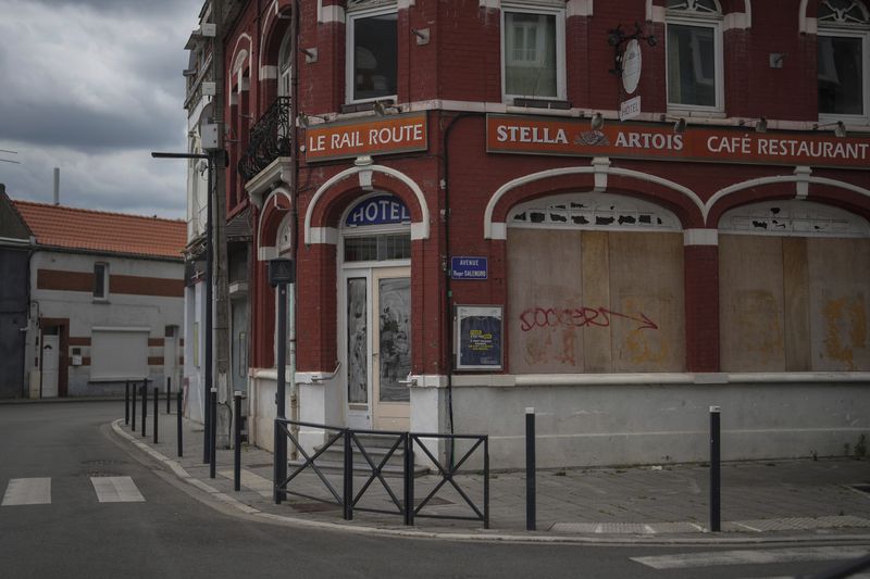 A closed shop is pictured near the railway station of Henin-Beaumont, northern France, Sunday, June 30, 2024. A depressed former mining town is at the heart of French far-right leader Marine Le Pen's long-term political strategy. Her party's electoral success Sunday came as no surprise to the hundreds of fierce supporters who had gathered in the town of Henin-Beaumont to see her victory speech. (AP Photo/Thibault Camus)