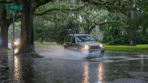 A car drives through a flooded street on Monday, August 5, 2024 in Savannah, GA. (AJC Photo/Katelyn Myrick)