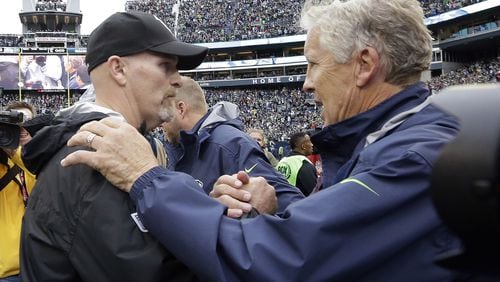 Seattle Seahawks coach Pete Carroll, right, greets Falcons coach Dan Quinn after an NFL football game, Sunday, Oct. 16, 2016, in Seattle. (AP Photo/Elaine Thompson)