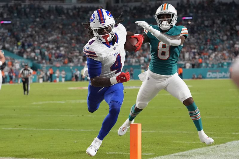 Buffalo Bills running back James Cook (4) scores a touchdown during the first half of an NFL football game against the Miami Dolphins, Thursday, Sept. 12, 2024, in Miami Gardens, Fla. (AP Photo/Lynne Sladky)