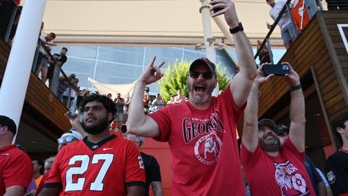 Georgia fans cheer as players and staff arrive during Dawgs Walk before an NCAA football game against Clemson at Mercedes-Benz Stadium, Saturday, August 31, 2024, in Atlanta. (Hyosub Shin / AJC)