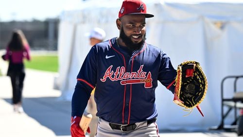 Braves designated hitter Marcell Ozuna smiles as he walks to the baseball field during the first full-squad spring training workout at CoolToday Park, Tuesday, February, 20, 2024, in North Port, Florida. (Hyosub Shin / Hyosub.Shin@ajc.com)