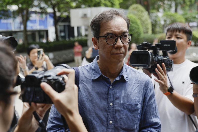 Chung Pui-kuen, the former chief editor of Hong Kong's now shuttered pro-democracy news outlet Stand News, walks past waiting media as he arrives at the Wanchai District Court ahead of the final sentencing of Stand News sedition case in Wan Chai district court in Hong Kong on Thursday, Sept. 26, 2024. (AP Photo/May James)