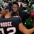 Atlanta Falcons head coach Raheem Morris celebrates with wide receiver KhaDarel Hodge (12) after scoring against the Tampa Bay Buccaneers during overtime in an NFL football game Thursday, Oct. 3, 2024, in Atlanta. (AP Photo/John Bazemore)