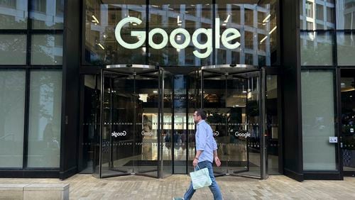 A man walks past Google's offices in London's Kings Cross area, on Aug. 10, 2024. (AP Photo/Brian Melley)