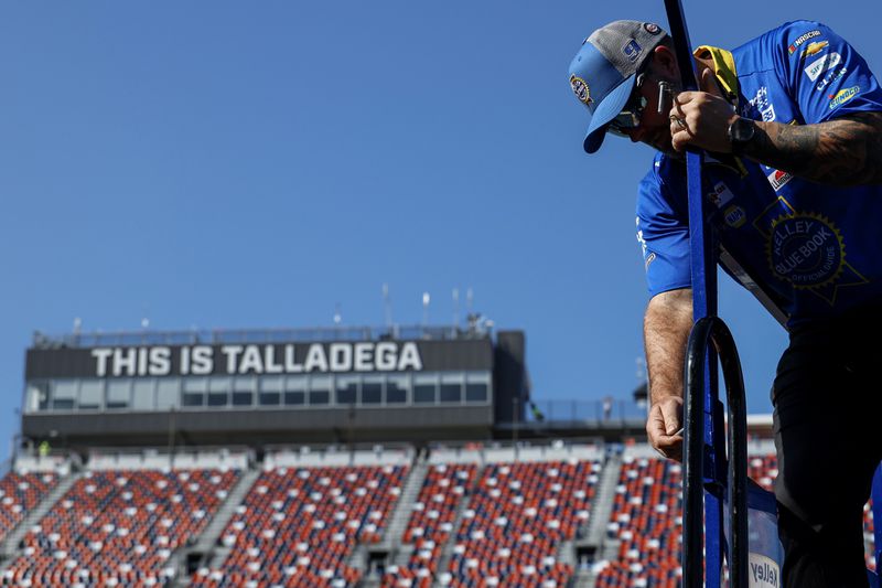 A crew member of driver Chase Elliott (9) preps the Pit Stall before a NASCAR Cup Series auto race at Talladega Suoperspeedway, Sunday, Oct. 6, 2024, in Talladega, Ala. (AP Photo/ Butch Dill)