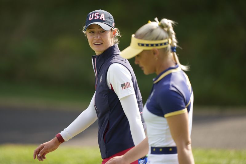 United States' Nelly Korda talks to Europe's Charley Hull as they walk on the fifth fairway during a Solheim Cup golf tournament singles match at the Robert Trent Jones Golf Club, Sunday, Sept. 15, 2024, in Gainesville, Va. (AP Photo/Matt York)