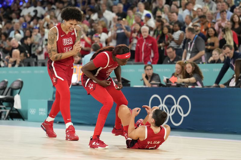 United States' Brittney Griner (15) United States' Kahleah Copper (7) and United States' Kelsey Plum (5) celebrate after a women's gold medal basketball game at Bercy Arena at the 2024 Summer Olympics, Sunday, Aug. 11, 2024, in Paris, France. (AP Photo/Mark J. Terrill)