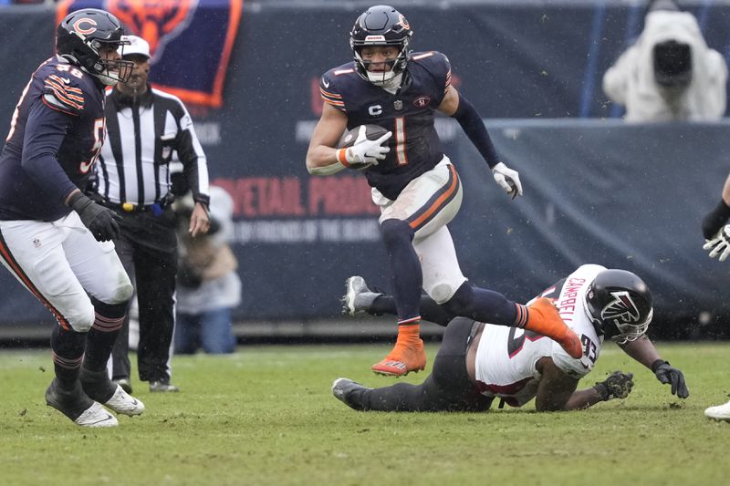 Bears quarterback Justin Fields (1) breaks away in the second half of a game against the Falcons in Chicago, Sunday, Dec. 31, 2023. (AP Photo/Charles Rex Arbogast)