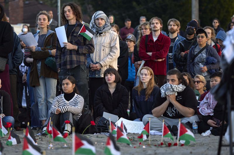 Attendees listen to speakers during a vigil on Alki Beach for the death of the 26-year old Aysenur Ezgi Eygi, killed recently in the occupied West Bank, Wednesday, Sept. 11, 2024, in Seattle. Eygi grew up in Seattle, attended Seattle Public Schools and graduated from the University of Washington. (AP Photo/John Froschauer)