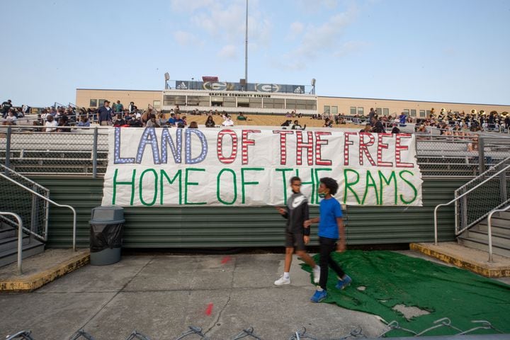 Fans walk by a sign that reads "Land of the free, home of the Rams" during a GHSA high school football game between Grayson High School and Archer High School at Grayson High School in Loganville, GA., on Friday, Sept. 10, 2021. (Photo/Jenn Finch)