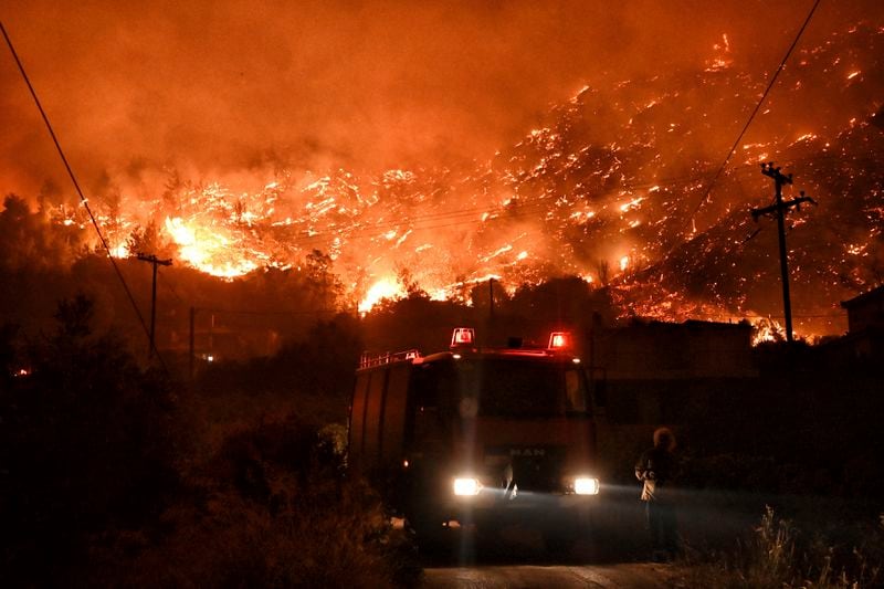 A wildfire approaches the village of Ano Loutro as fanned by strong winds raged uncontrolled despite the attempts of hundreds of firefighters to stop it, some 131 kilometers (81 miles) west of Athens, Greece, in the region of Corinthia, late Sunday, Sept. 29, 2024. (AP Photo)