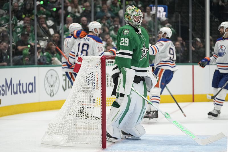 Dallas Stars goaltender Jake Oettinger (29) stands by the net as the Edmonton Oilers celebrate a goal by Zach Hyman (18) during the second period of Game 1 of the Western Conference finals in the NHL hockey Stanley Cup playoffs Thursday, May 23, 2024, in Dallas. (AP Photo/Tony Gutierrez)