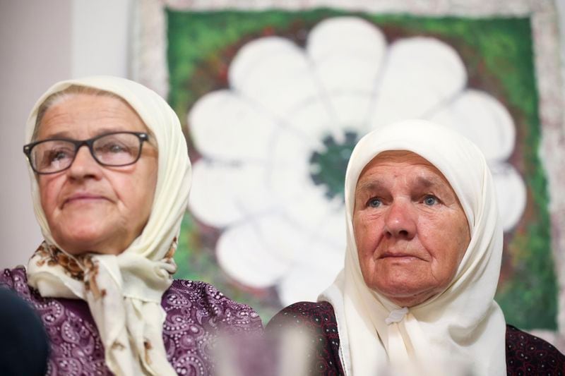 Mejra Djogaz, right, member of the association Mothers of Srebrenica watches the United Nations General Assembly session where voting on a draft resolution declaring July 11 the International Day of Reflection and Commemoration of the 1995 genocide in Srebrenica takes place, in Potocari, Bosnia, Thursday, May 23, 2024. (AP Photo/Armin Durgut)