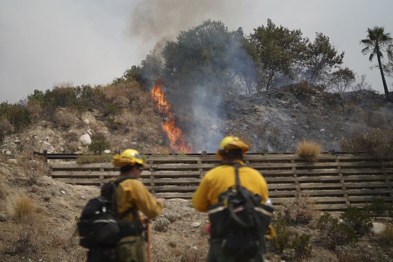 Fire crews monitor the Line Fire Saturday, Sept. 7, 2024, in Highland, Calif. (AP Photo/Eric Thayer)