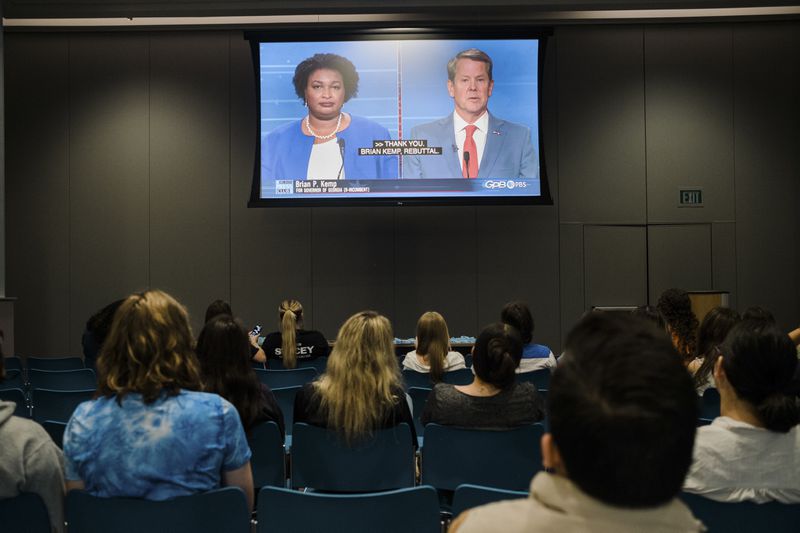 Students attend a watch party to see the gubernatorial debate between Democratic challenger Stacey Abrams, Libertarian challenger Shane Hazel and Georgia Republican Gov. Brian Kemp, at Emory University, Atlanta, on Oct. 17, 2022. (Gabriela Bhaskar/The New York Times)