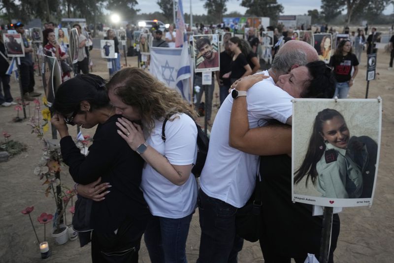 People visit the site of the Nova music festival, where hundreds of revelers were killed and abducted by Hamas and taken into Gaza, on the one-year anniversary of the attack, near Kibbutz Reim, southern Israel, Monday, Oct. 7, 2024. (AP Photo/Ariel Shalit)