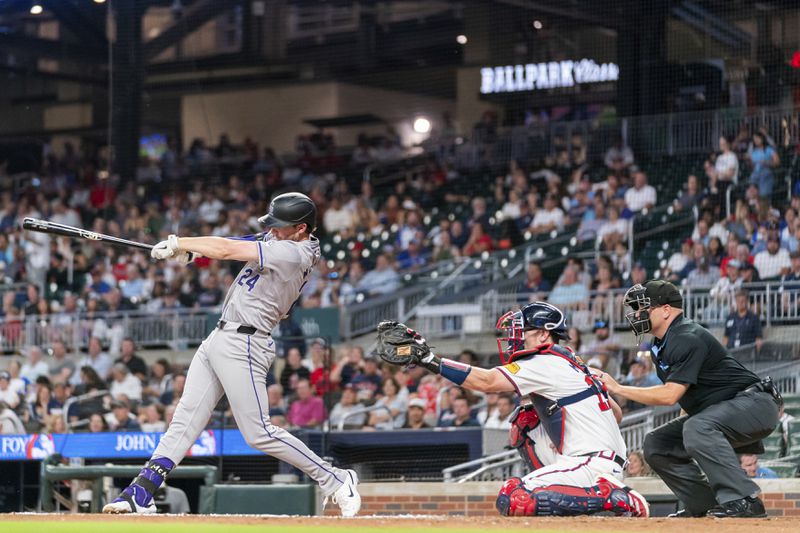 Colorado Rockies' Ryan McMahon (24) hits a single to center in the fourth inning of a baseball game against the Atlanta Braves, Thursday, Sept. 5, 2024, in Atlanta. (AP Photo/Jason Allen)