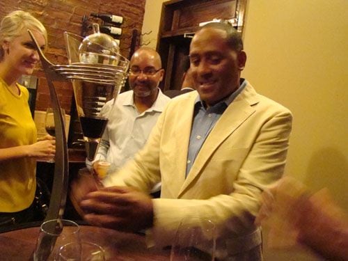 Frank Ski pouring wine at his opening party at Frank Ski's in September, 2011. CREDIT: Rodney Ho/rho@ajc.com