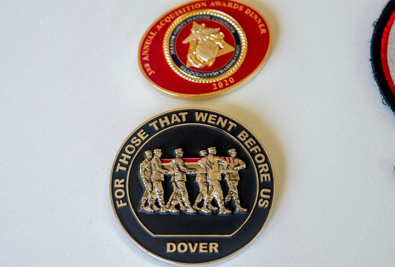 "Challenge coins" belonging to Marine Corporal Spencer R. Collart, are seen at the home of his parents in Arlington, Va., Thursday, June 19, 2024. Collart, 21, was killed along with two other Marines when the MV-22B Osprey aircraft they were on crashed during drills on a north Australian island on August 27, 2023. (AP Photo/Rod Lamkey, Jr.)