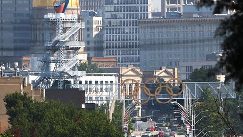 The Olympic cauldron and rings against the Atlanta skyline in 2021. (Curtis Compton/AJC 2021)