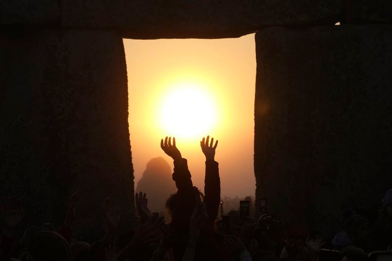 FILE - Revelers gather at the ancient stone circle Stonehenge to celebrate the summer solstice, the longest day of the year, near Salisbury, England, June 21, 2023. Summer kicks off in the Northern Hemisphere once again with the summer solstice on Thursday, June 20, 2024. (AP Photo/Kin Cheung, File)