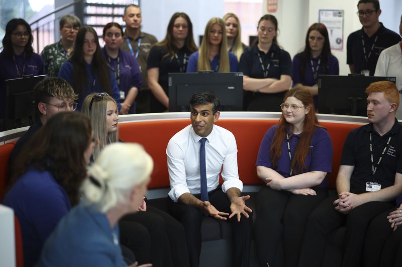 Britain's Prime Minister and Conservative Party leader Rishi Sunak, center, takes part in a Q&A session with students and staff at Cannock College, in Cannock, central England, Friday May 24, 2024, during a campaign event in the build-up to the UK general election on July 4. (Henry Nicholls/Pool via AP)