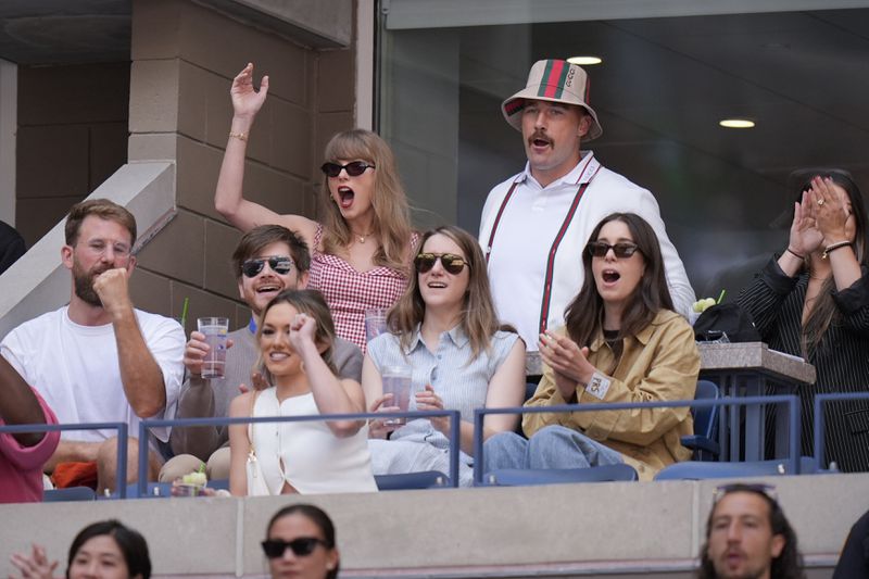 Taylor Swift and Kansas City Chiefs tight end Travis Kelce, watch play between Jannik Sinner, of Italy, and Taylor Fritz, of the United States, during the men's singles final of the U.S. Open tennis championships, Sunday, Sept. 8, 2024, in New York. (AP Photo/Seth Wenig)