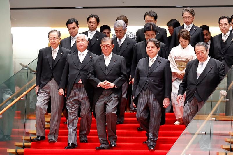 Japan's Prime Minister Shigeru Ishiba, 3rd from left, and his cabinet ministers pose for a photo session at Ishiba's residence in Tokyo, Japan, Tuesday, Oct. 1, 2024. Rodrigo Reyes Marin, Pool Photo via AP)