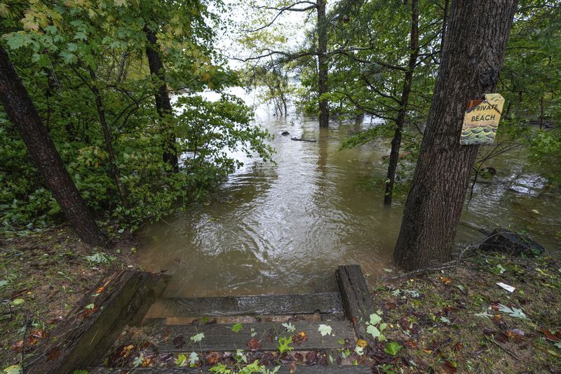 A beach on Lake James is flooded from torrential rain as a result of Hurricane Helene on Friday, Sept. 27, 2024 in Morganton, N.C. (AP Photo/Kathy Kmonicek)