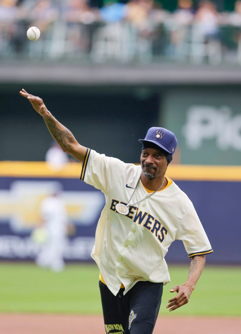 FILE - Snoop Dogg throws out the ceremonial first pitch before a baseball game between the Milwaukee Brewers and the Cincinnati Reds Saturday, June 15, 2024, in Milwaukee. (AP Photo/Jeffrey Phelps, File)