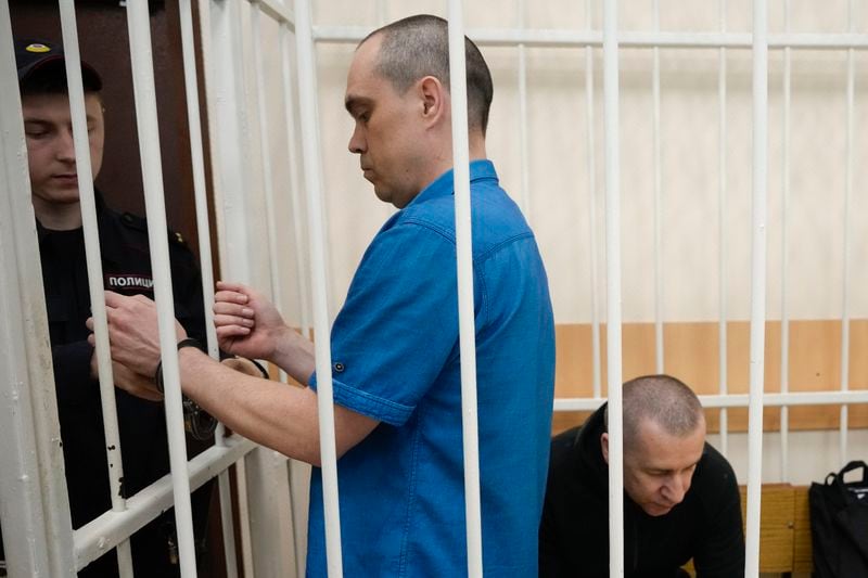 Former Navalny's lawyers Vadim Kobzev, center, and Igor Sergunin, right, appear in the cage during a court session in Petushki, Vladimir region, about 120 kilometers (75 miles) east of Moscow, Russia, Thursday, Sept. 12, 2024. (AP Photo/Alexander Zemlianichenko)