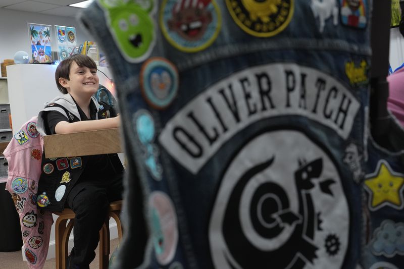 Oliver Burkhardt, 13, smiles during an interview inside the offices of the Oliver Patch Project, Wednesday, Sept. 4, 2024, in Miami. (AP Photo/Rebecca Blackwell)