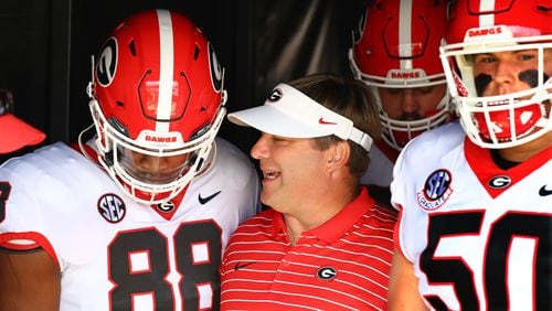 Georgia coach Kirby Smart confers with tight end Jesse Sanders while taking the field to play South Carolina in a NCAA college football game on Saturday, Sept. 17, 2022, in Columbia.   “Curtis Compton / Curtis Compton@ajc.com