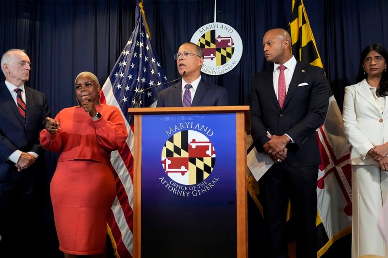 Maryland Attorney General Anthony Brown, center, speaks during a press conference announcing a lawsuit seeking damages from the owners and managers of the Dali cargo ship that crashed into the Francis Key Scott Bridge, Tuesday, Sept. 24, 2024, in Baltimore. (AP Photo/Stephanie Scarbrough)