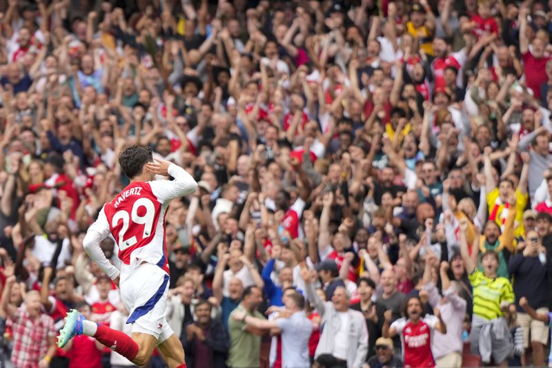 Arsenal's Kai Havertz celebrates after scoring his side's opening goal during the English Premier League soccer match between Arsenal and Brighton, at Emirates Stadium in London, Saturday, Aug. 31, 2024. (AP Photo/Alastair Grant)