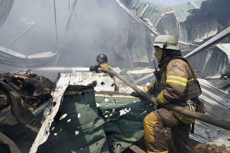 Firefighters put out a fire after a Russian missile hit a large printing house in Kharkiv, Ukraine, Thursday, May 23, 2024. Russian missiles slammed into Ukraine’s second-largest city in the northeast of the country and killed at least seven civilians early Thursday, officials said, as Kyiv’s army labored to hold off an intense cross-border offensive by the Kremlin’s larger and better-equipped forces. (AP Photo/Andrii Marienko)