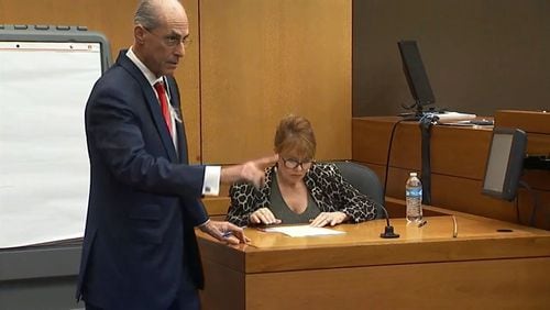 Defense attorney Bruce Harvey has witness Dani Jo Carter look at a document during the murder trial of Tex McIver on Tuesday. “Wasn’t that just the dumbest thing?” he said of McIver’s request for Carter to lie about her involvement in the shooting. (Channel 2 Action News)