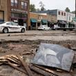 A Madison County sheriff's vehicle passes damaged buildings along Bridge Street in the aftermath of Hurricane Helene Tuesday, Oct. 1, 2024, in Hot Springs, N.C. (AP Photo/Jeff Roberson)